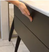 Elegant och modern badrumsinspiration med mörka marmorerade väggar, runda belysta speglar med svart ram, väggmonterat tvättställsskåp med dubbelhandfat och en rymlig duschnisch