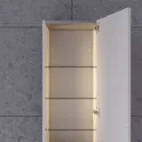 Stort badrum i gröna färger med tvättställsskåp, oval spegel med guldkant och vackra luckor med ram