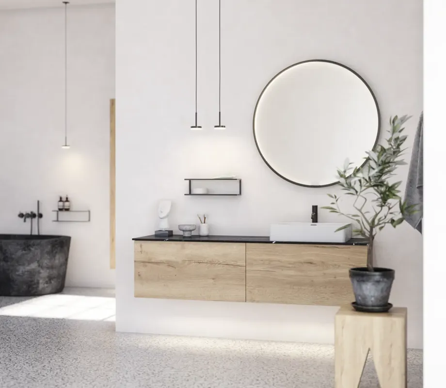 Stor urban badrumsinspiration med möbler i naturlig ek, stenbänkskiva med fyrkantig vask, runt spegel med svart kant, naturfärger och terrakottagolv ger en industriell och modern känsla